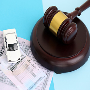 Gavel over parking tickets and toy car for Florida bankruptcy and license suspension law.